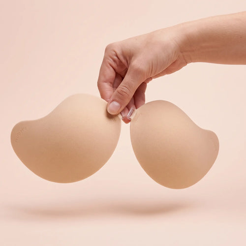 The Invisible Bra held up by its clasp to show the size of the cups