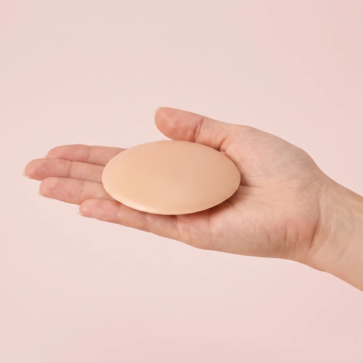 The Sculpt Round cover on an open hand to show its true size
