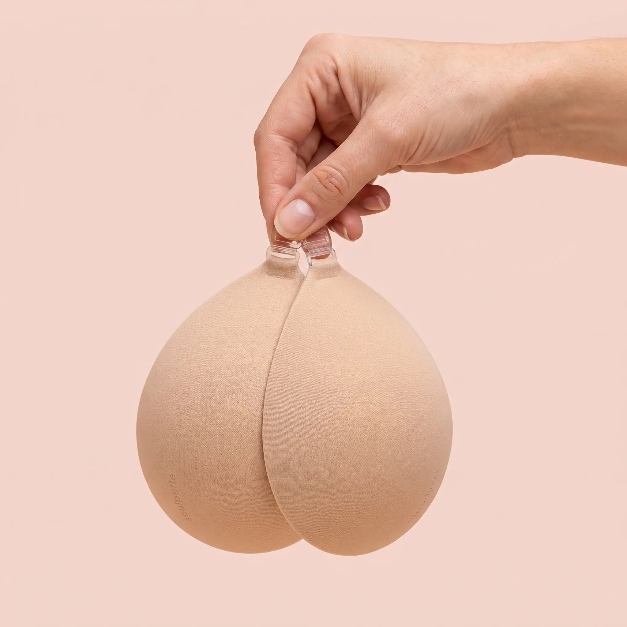 The Sticky Bra held up by its clasp to show the size of the cups