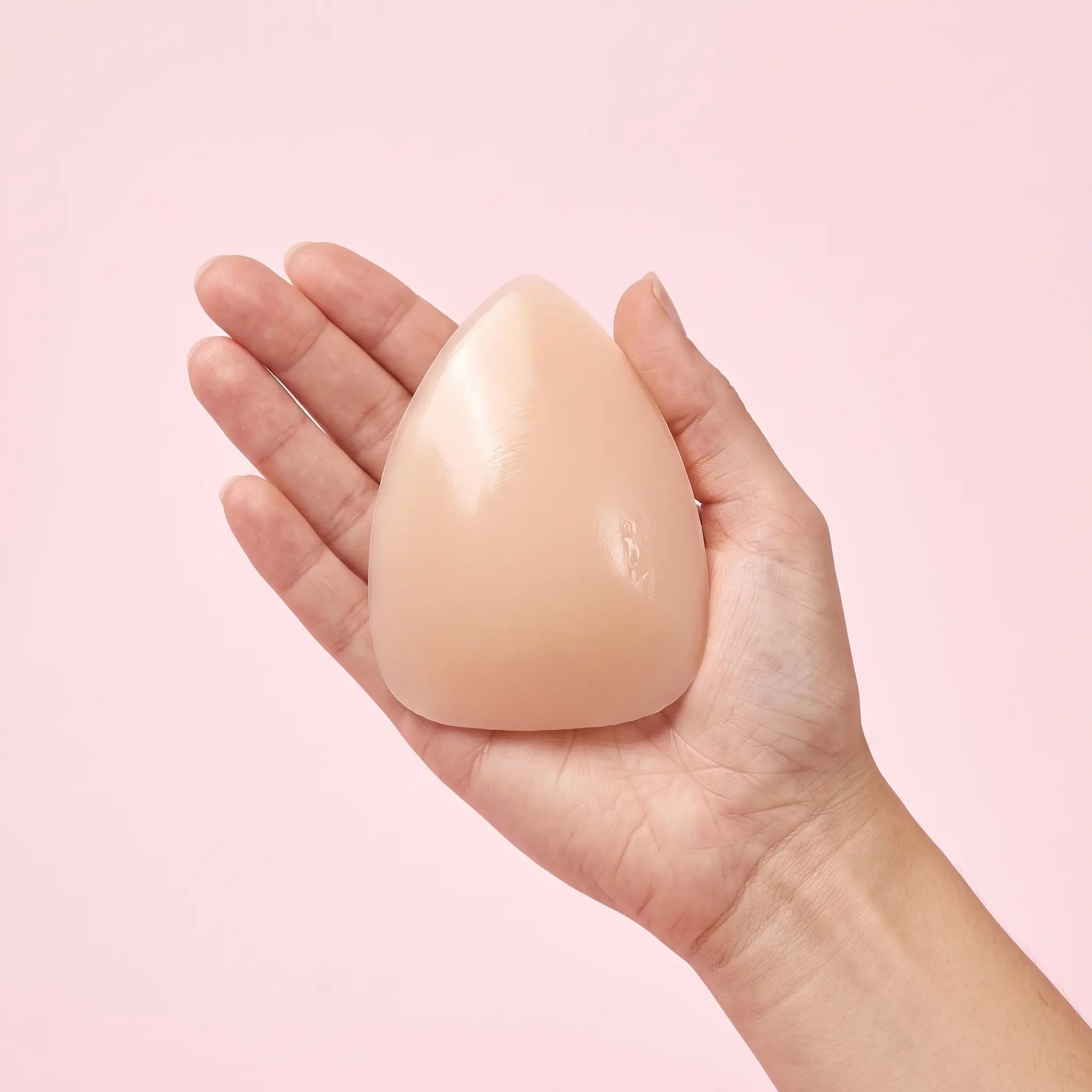 The Sculpt Lite insert on an open hand to show its true size